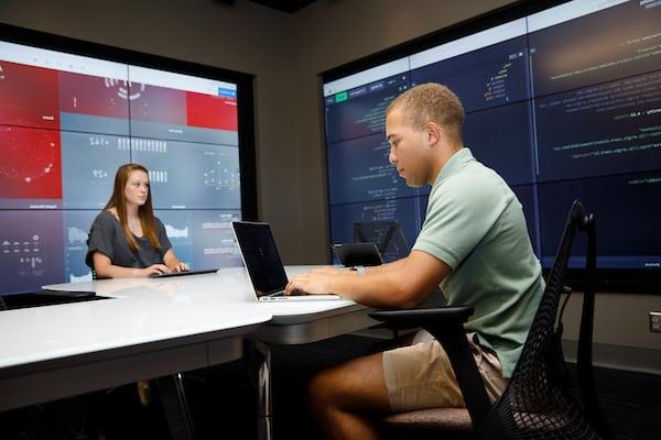 Two students work together in the Hewson Analytics Lab